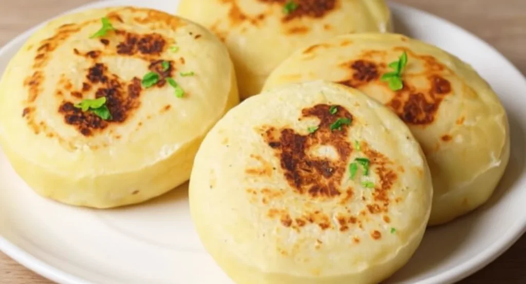 Homemade cheese pupusas recipe with golden crust on a white plate
